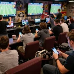 Fans passionately placing bets on 68win's sports betting app while enjoying the game atmosphere.